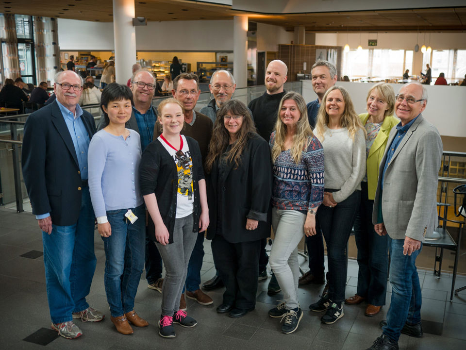 En gruppe mennesker inne i høgskolebygg