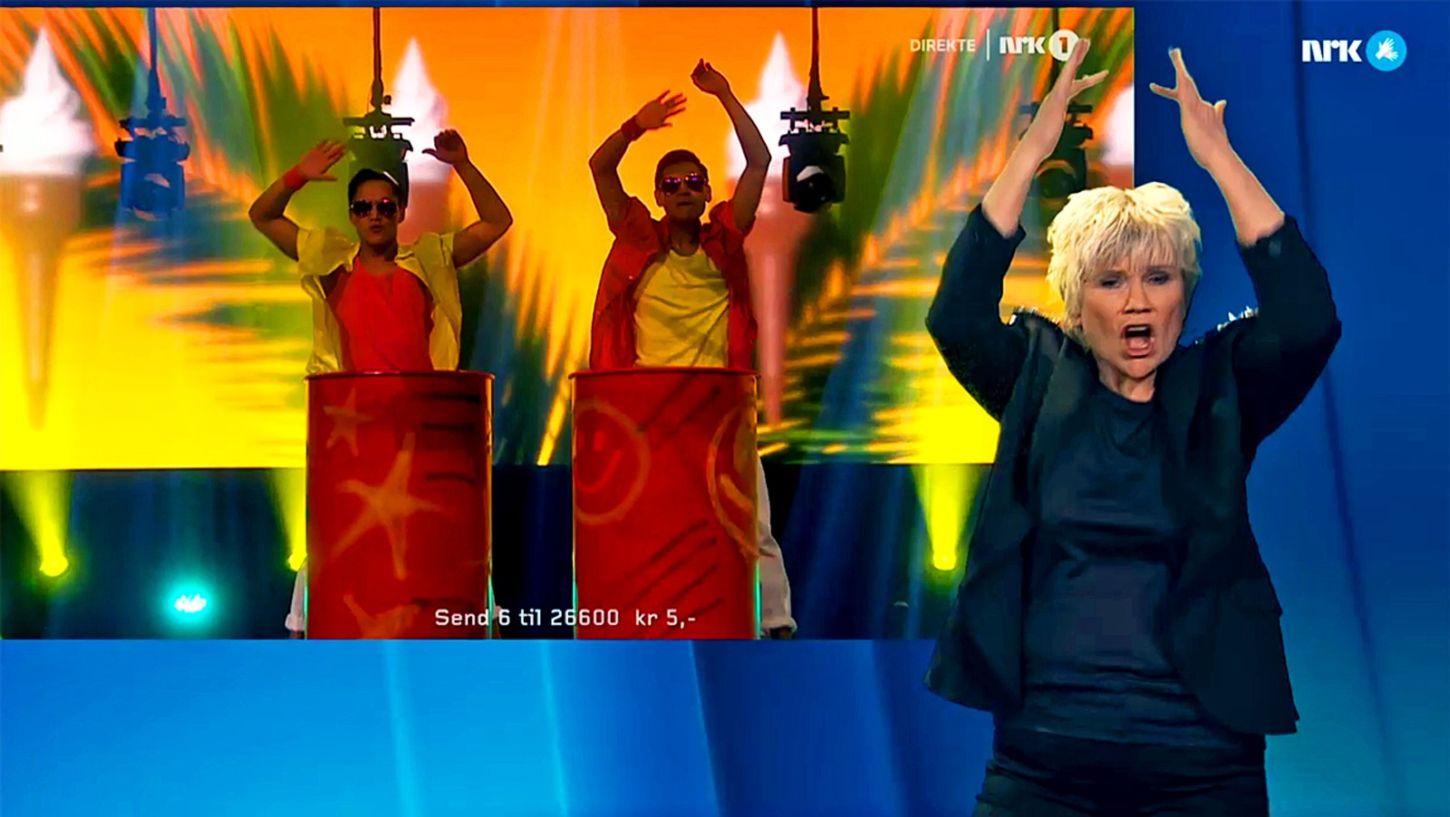 Dame danser foran skjerm.