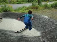 Child jumping in a pond