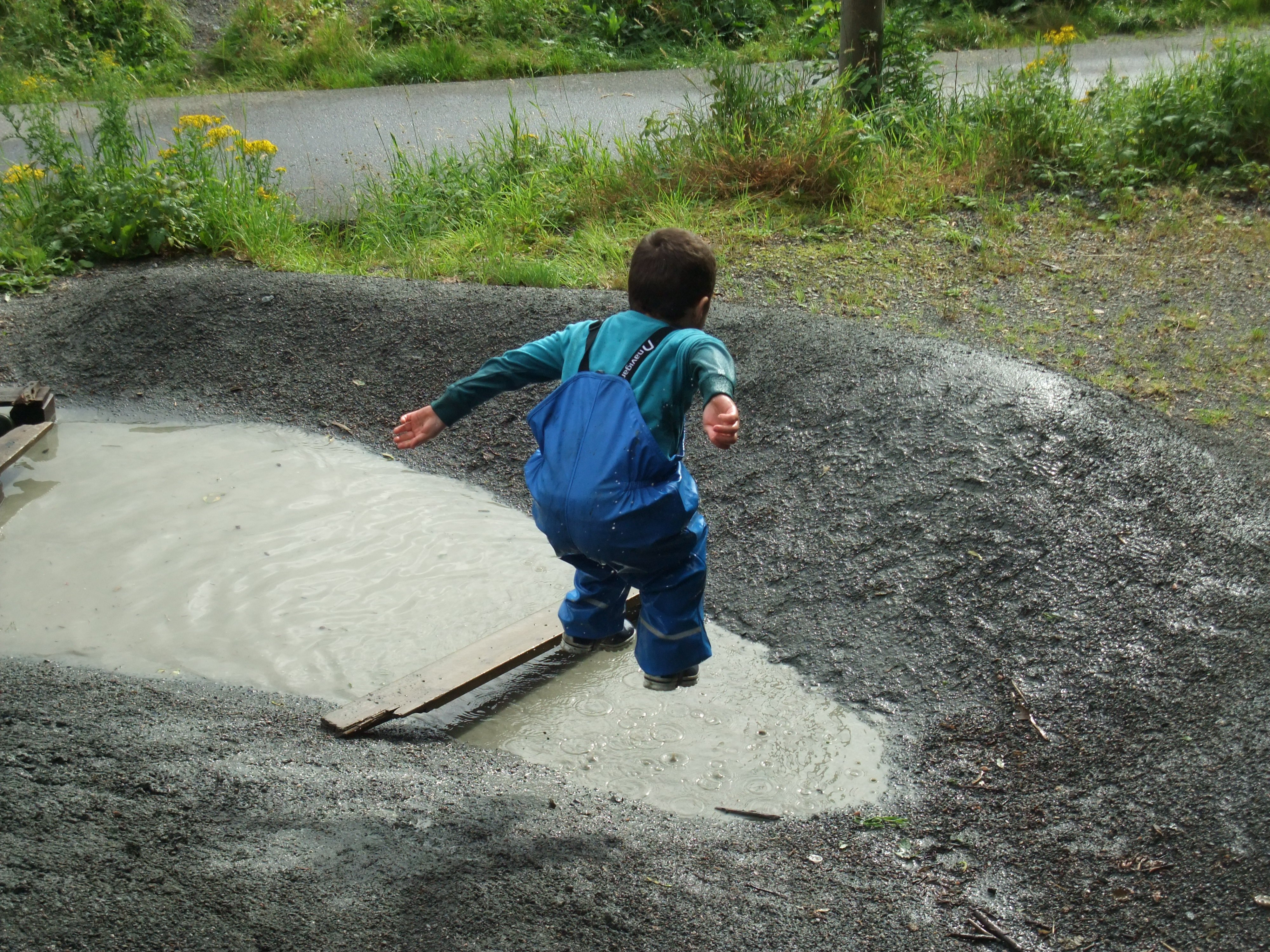 Child jumping in a pond