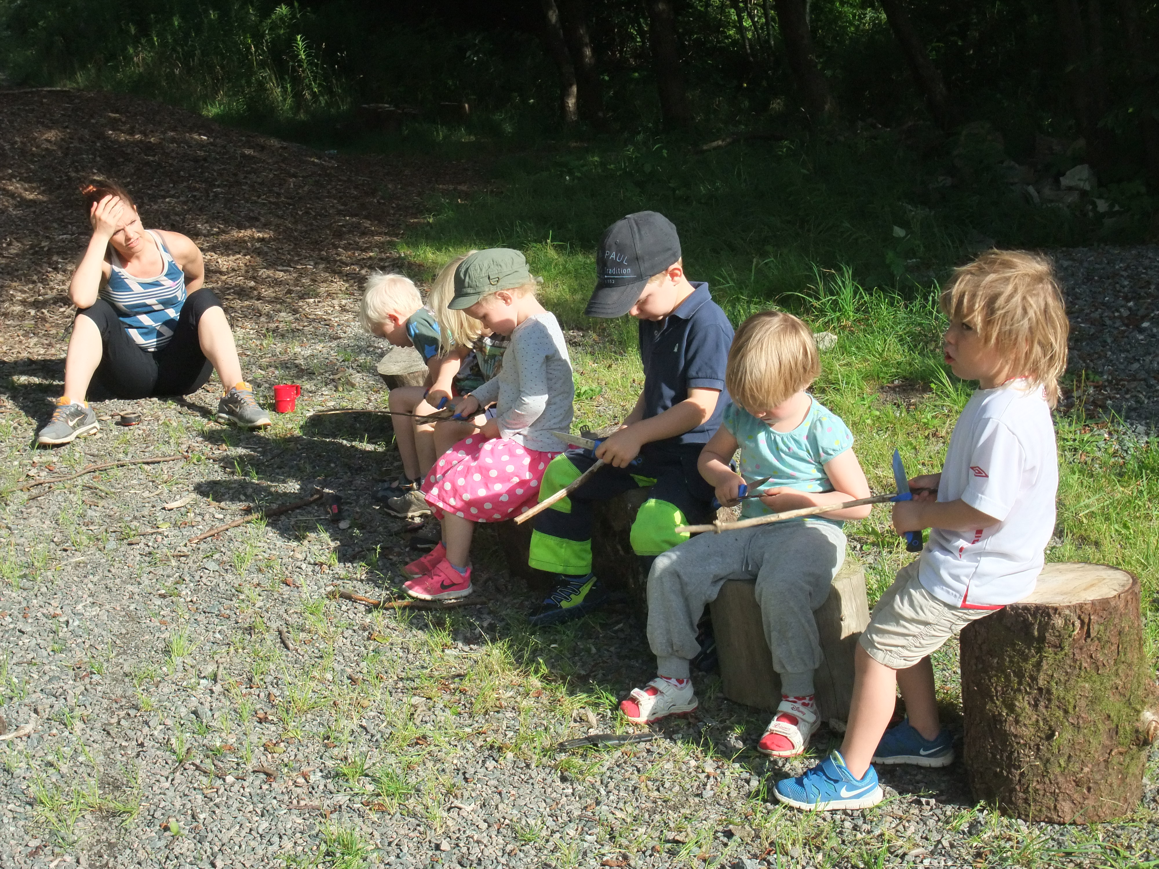 Children cutting in wood