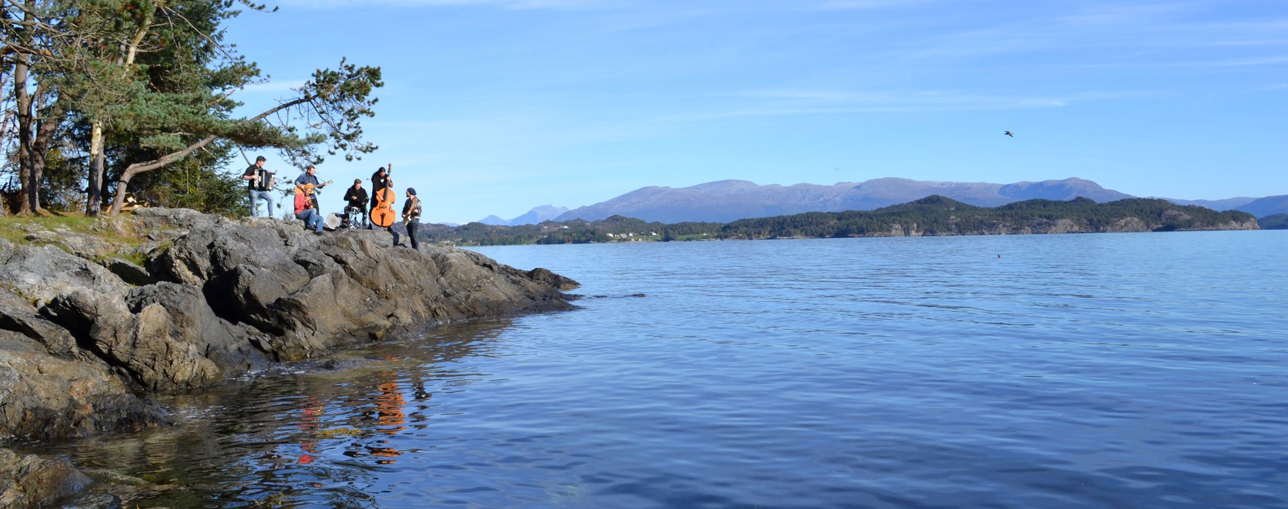 Students with instruments by the fjord