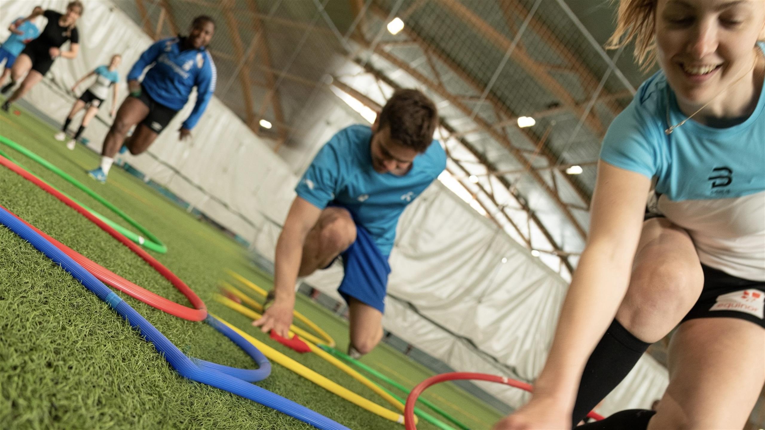 Sports students training in a sports hall.